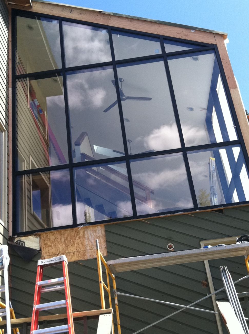 Two-story residential glass gable window wall