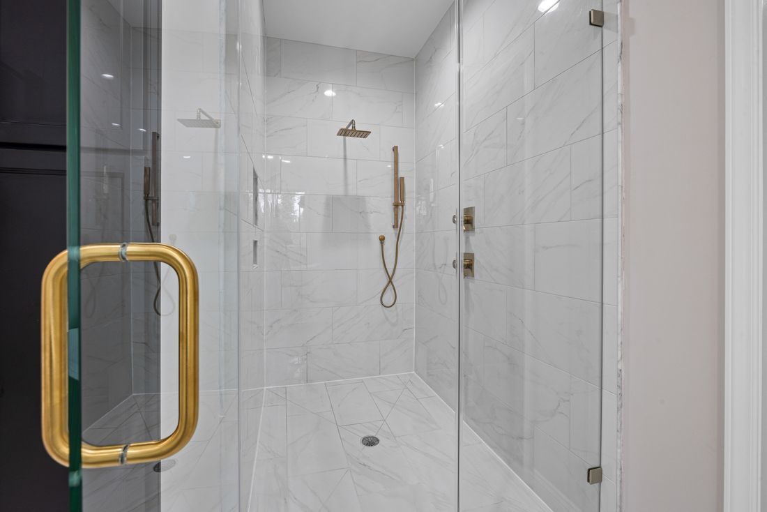 Custom frameless glass shower with premium fixtures